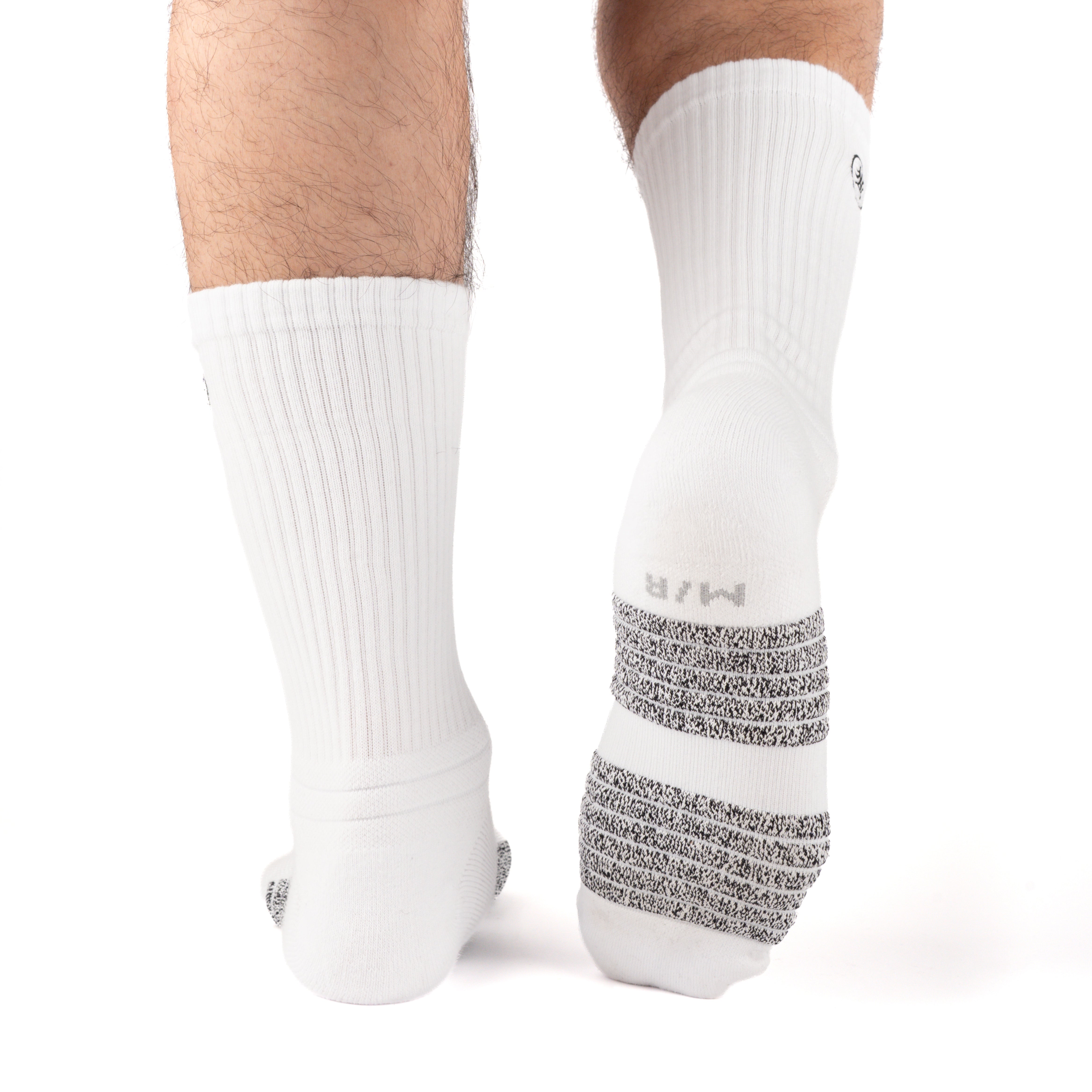 White Performance Crew Socks worn on model, rear view showing high-friction footbed