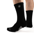 Black Performance Crew Socks worn on model, front three-quarter view