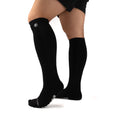 Black Performance Deadlift Socks worn on model, front three-quarter view