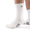 White Performance Crew Socks worn on model, front three-quarter view