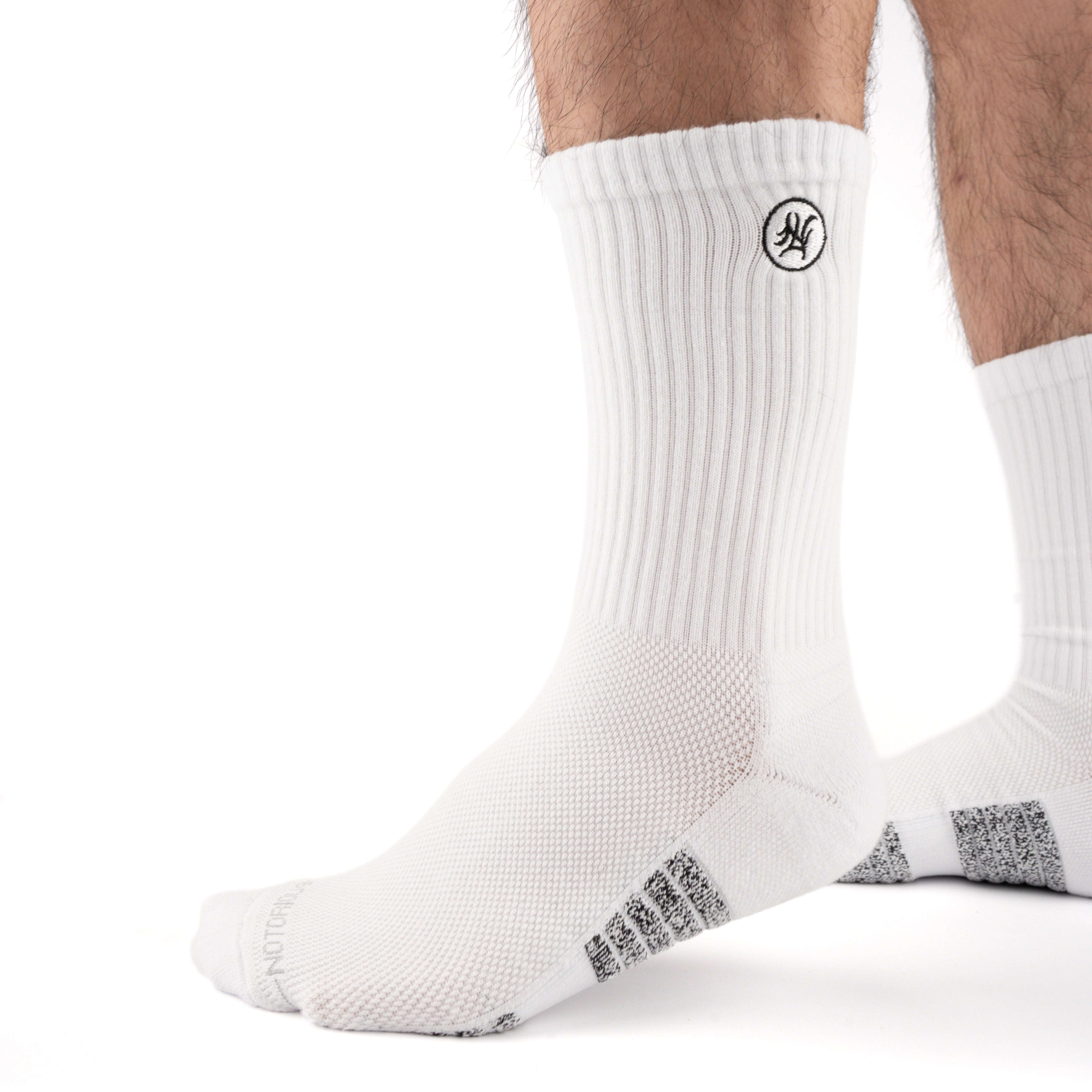White Performance Crew Socks worn on model, front three-quarter view