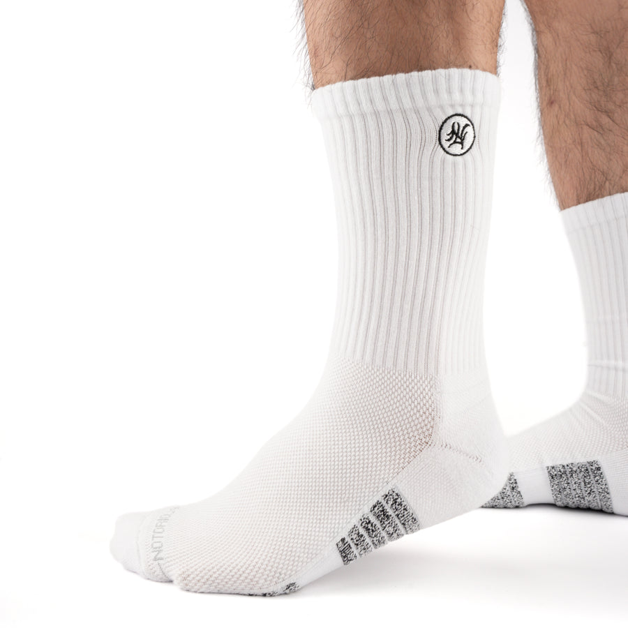White Performance Crew Socks worn on model, front three-quarter view