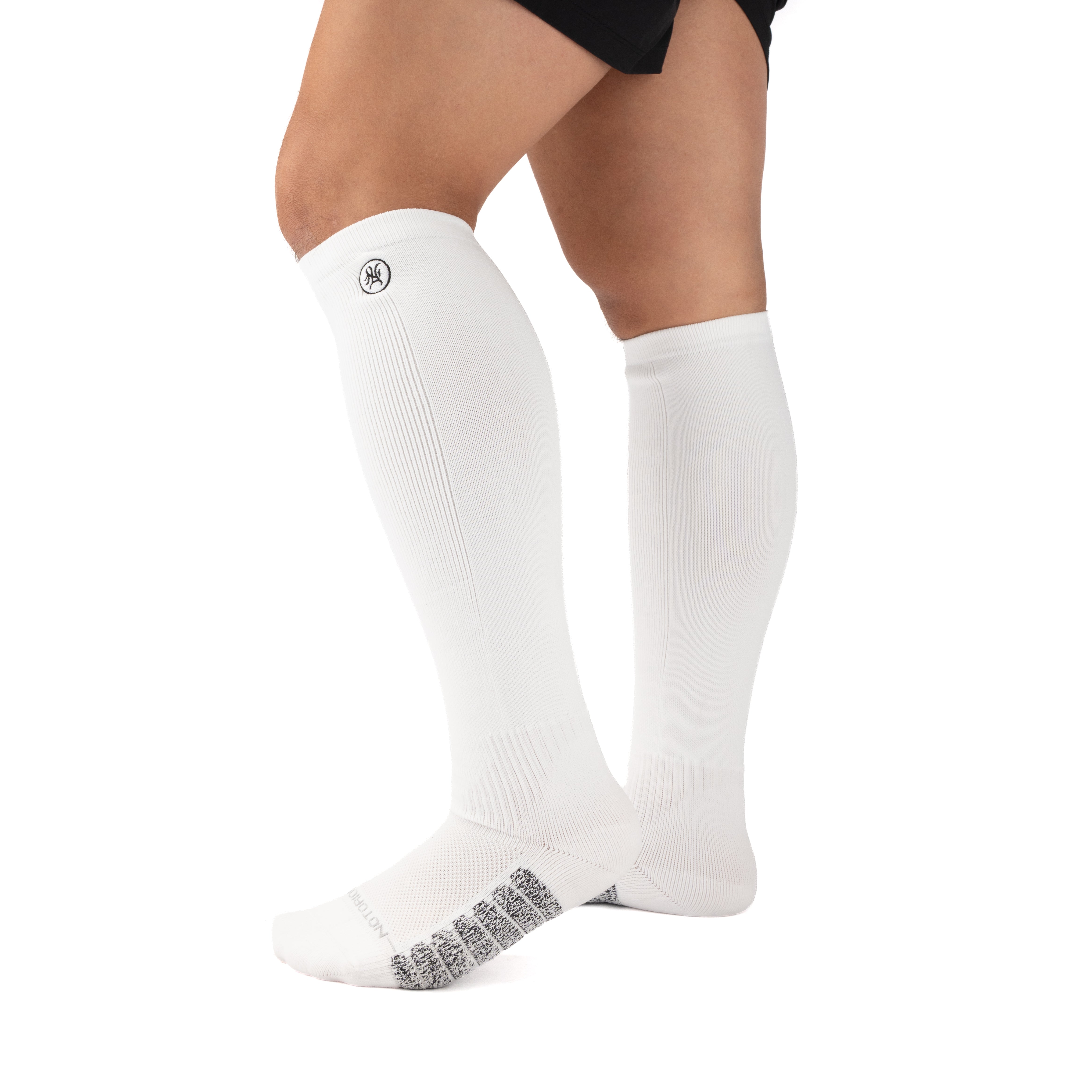 White Performance Deadlift Socks worn on model, front three-quarter view