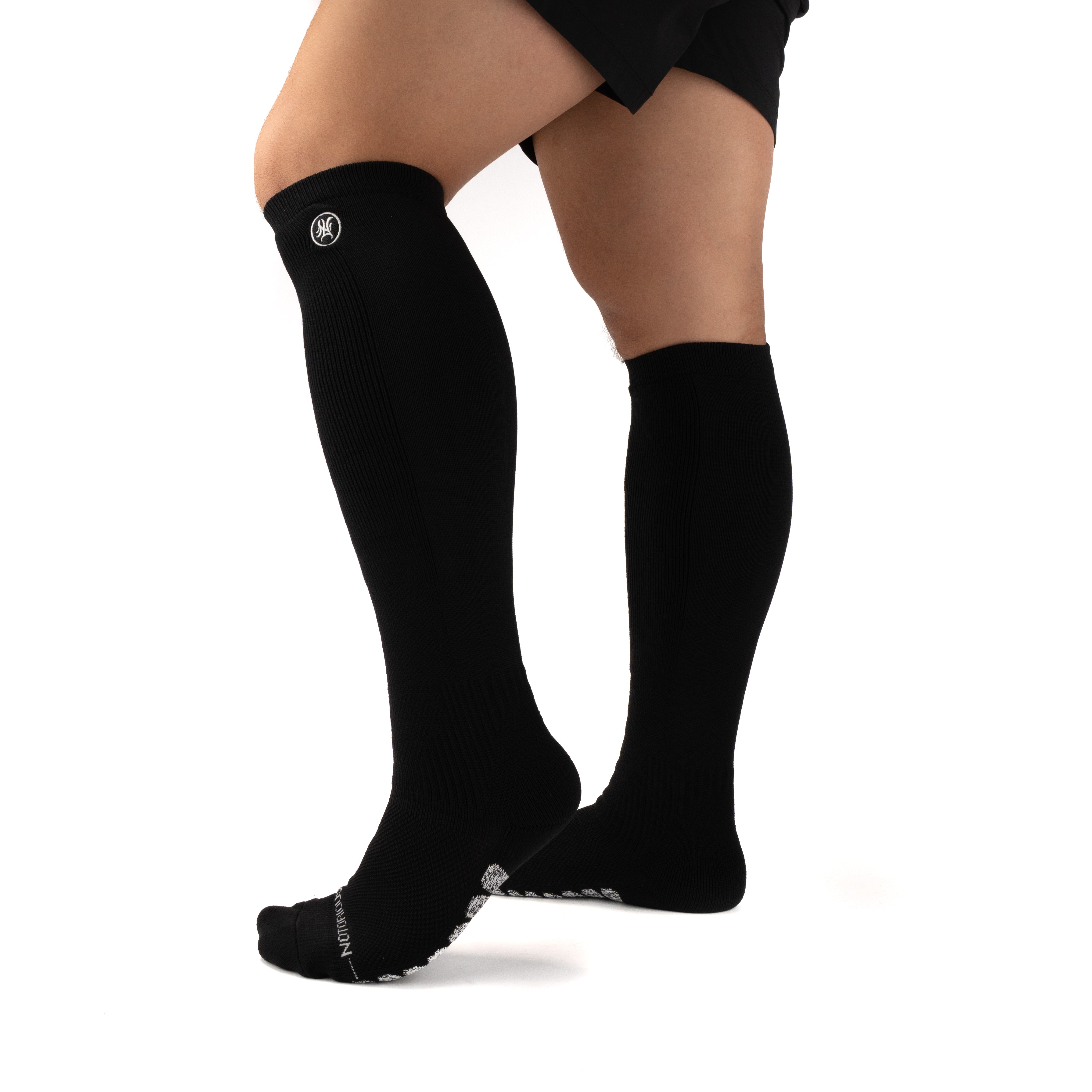 Black Performance Deadlift Socks worn on model, front three-quarter view