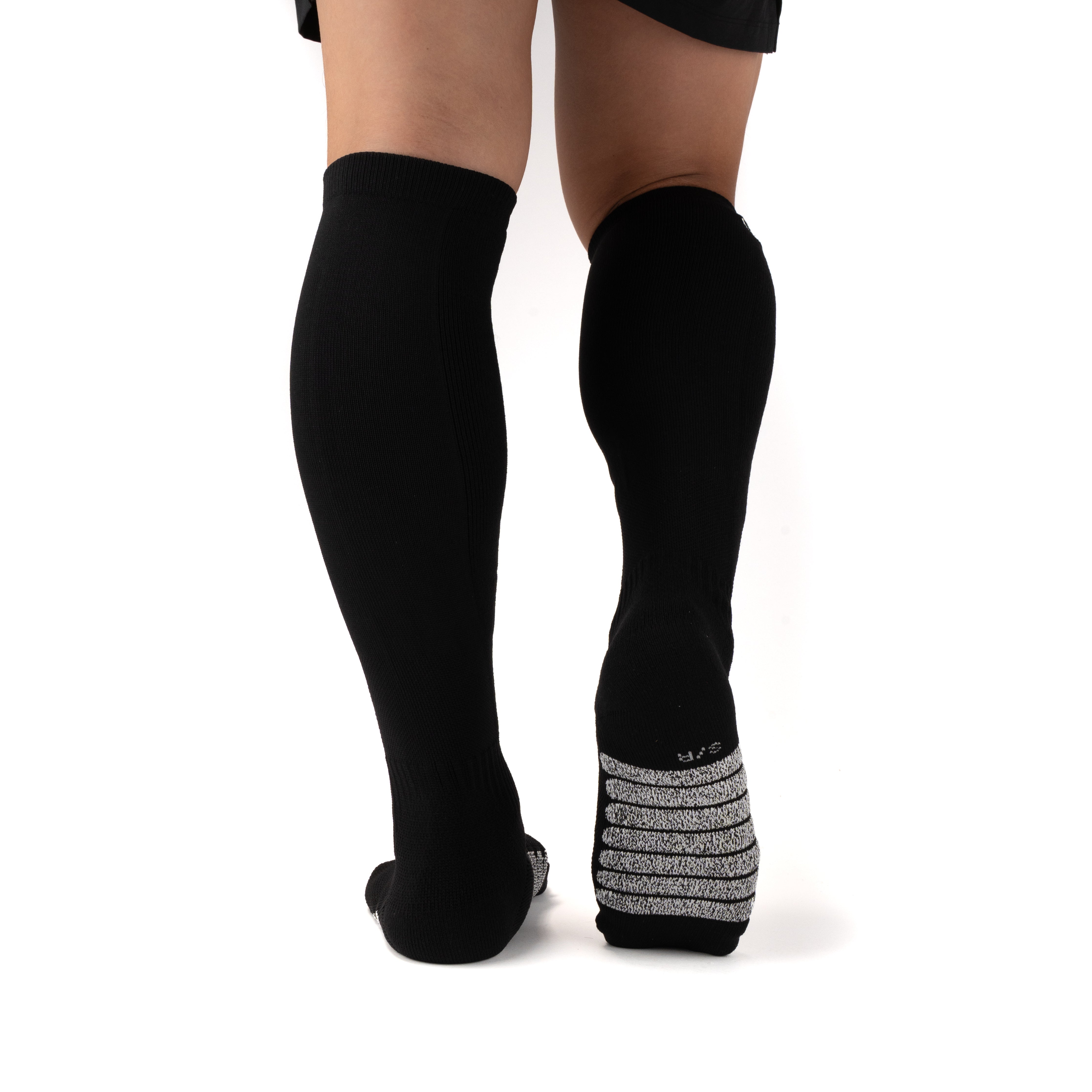 Black Performance Deadlift Socks worn on model, rear view showing high-friction footbed